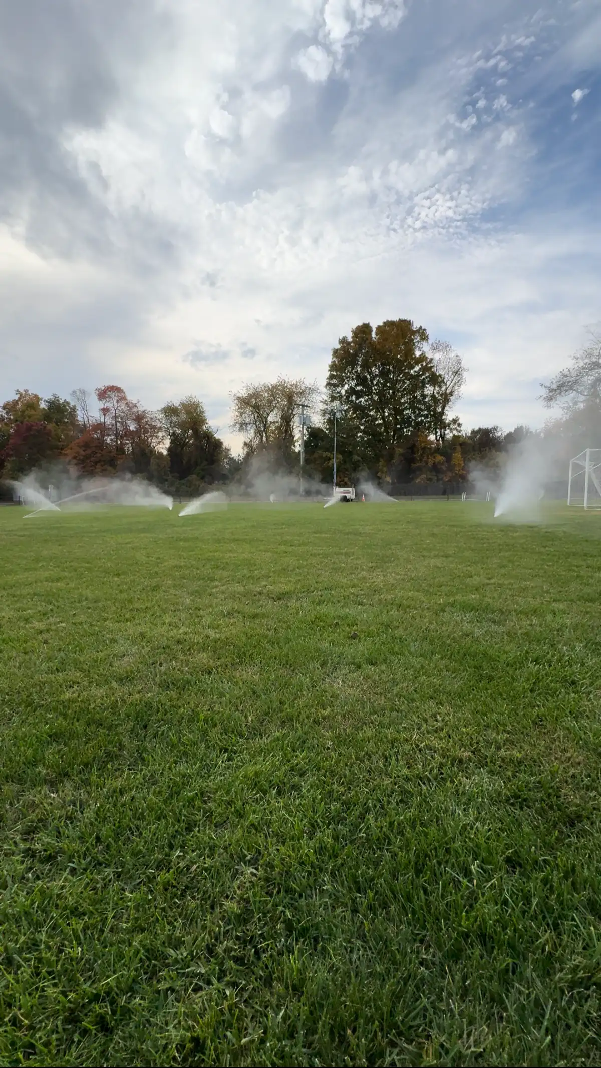 Sports field sprinkler system providing even turf coverage