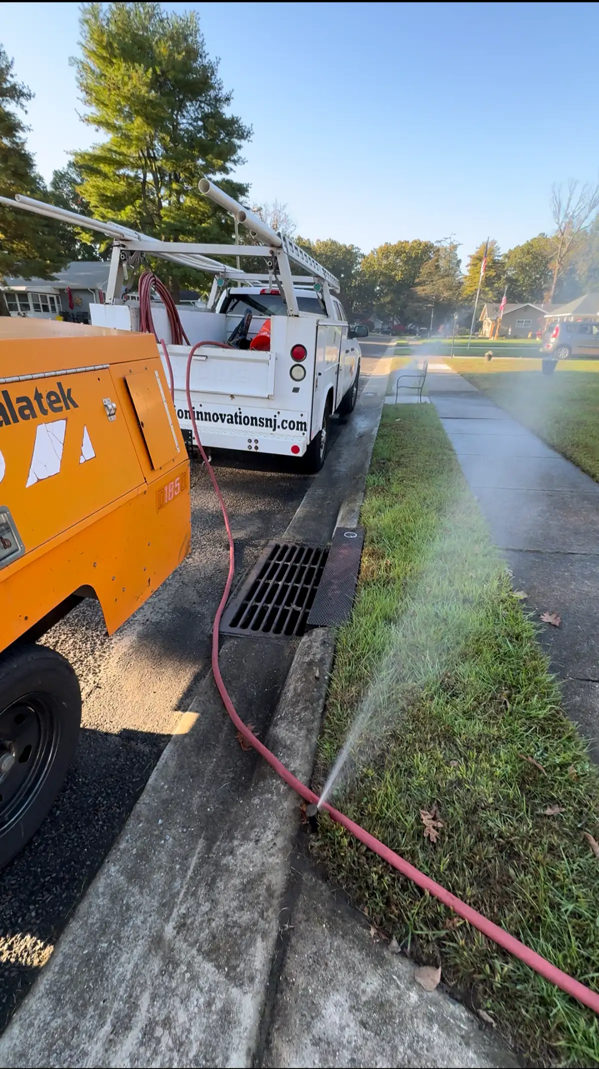 Irrigation winterization blowout service truck at a residential property